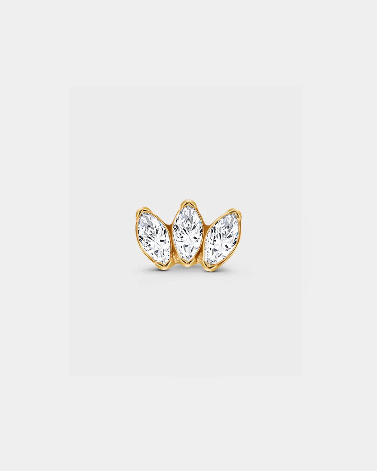 Gold titanium threadless earring with three bezel set clear marquise gemstone in a slight fan shape in a light grey background.