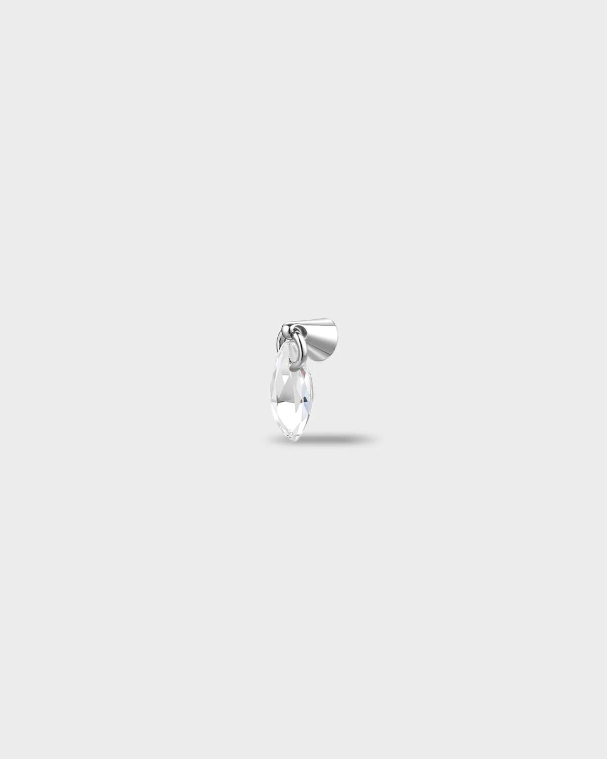 Polished titanium earring with a marquise-cut clear stone suspended from a smooth, tapered setting, on a light gray background.