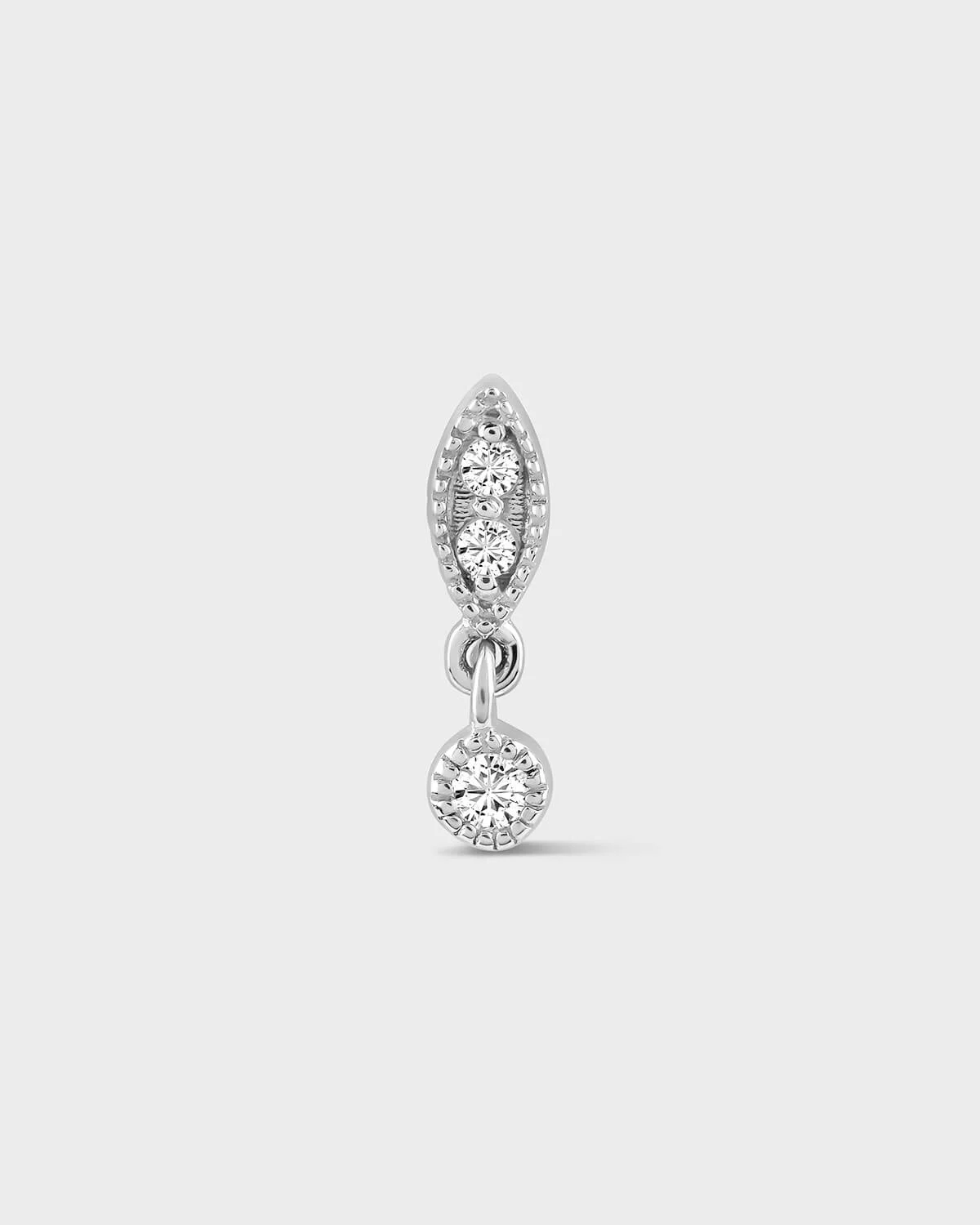 Diamond earring with two round diamonds on a light gray background