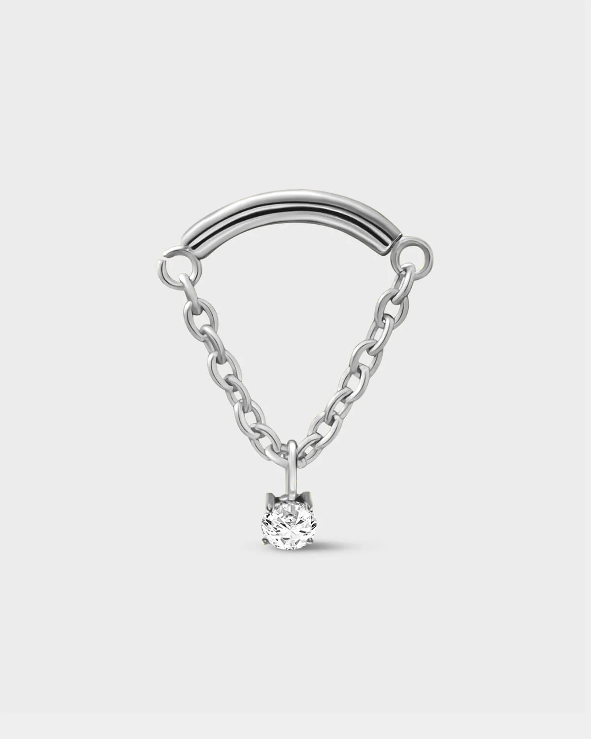 Polished silver titanium earring used for hidden helix or hidden rook featuring a smooth curved bar with a chain connected at each end and a single clear solitaire pendent on a light grey background.