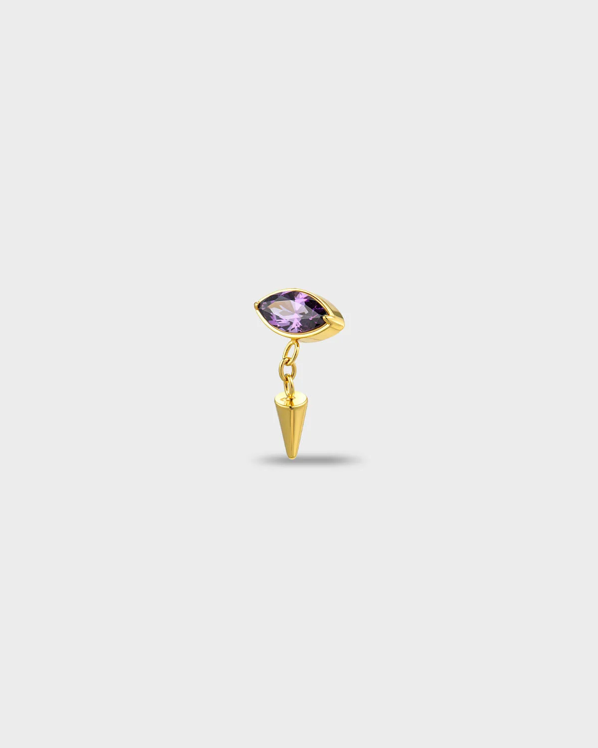 Gold titaniumearring with a marquise-cut purple stone and a short chain dangle finished with a polished spike, on a light gray background.