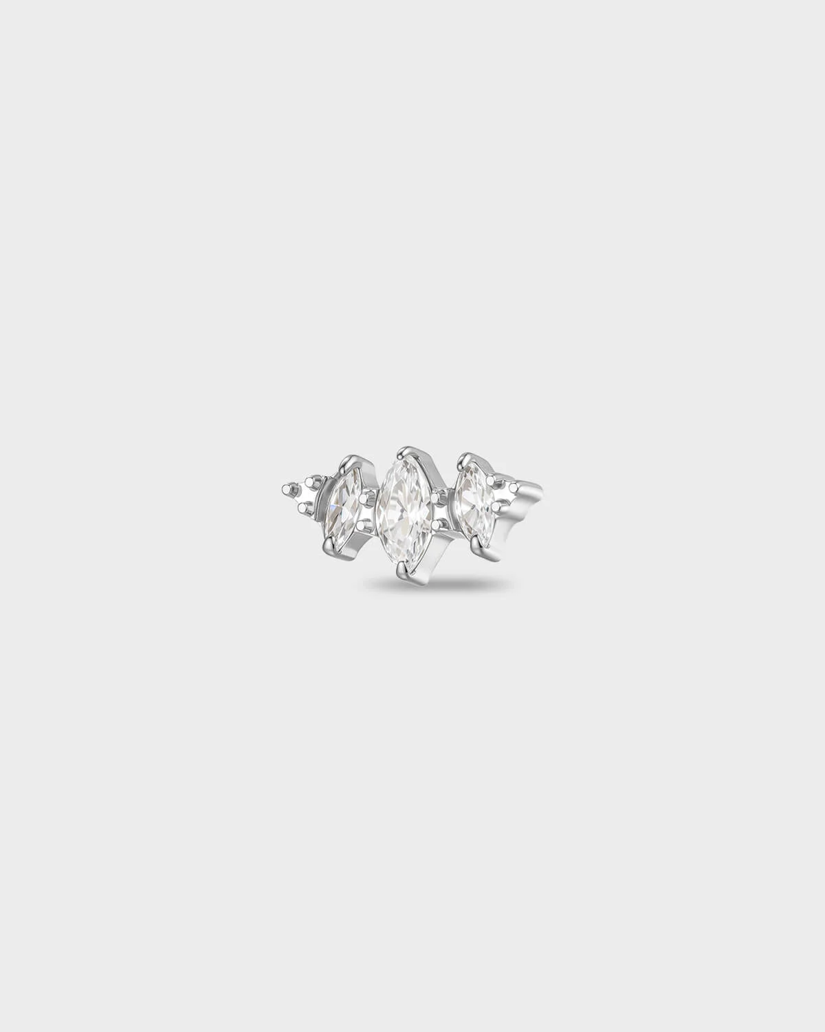 Polished titanium earring with three marquise-cut clear stones set in a stepped horizontal arrangement, on a light gray background.