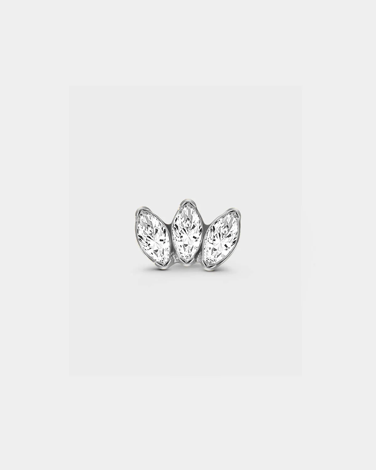 Polished silver titanium threadless earring with three bezel set clear marquise gemstone in a slight fan shape in a light grey background.