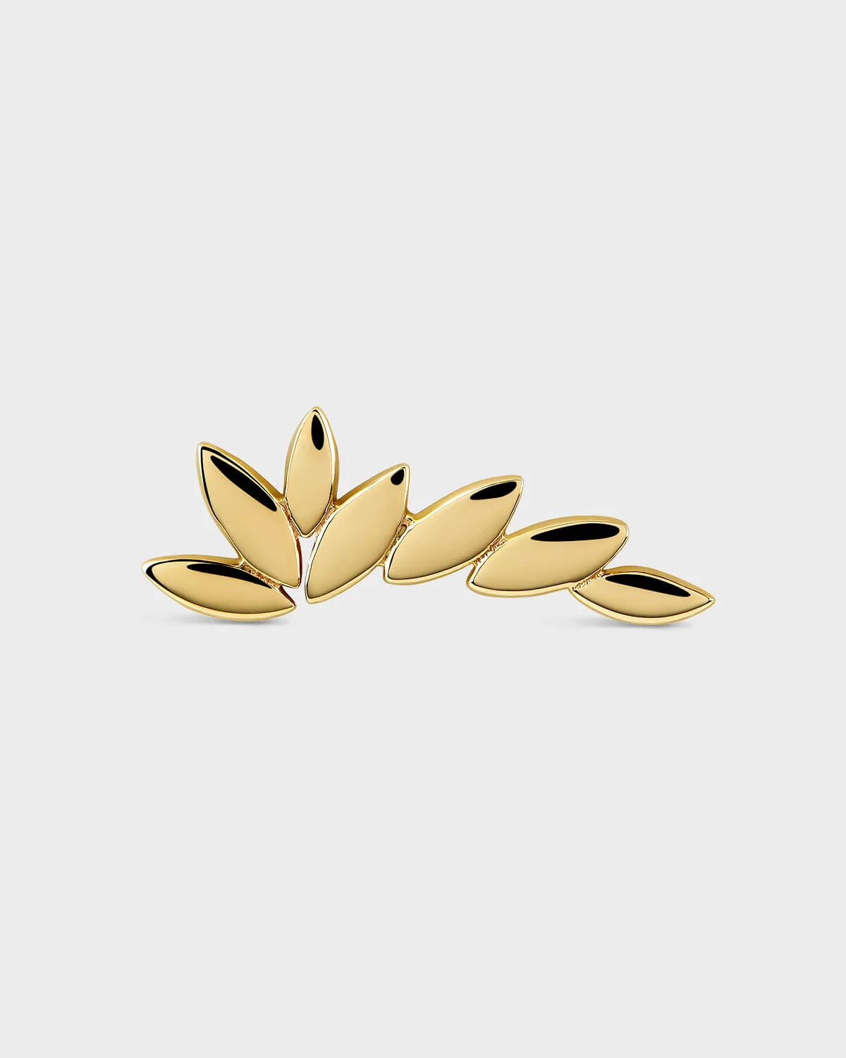 Gold wing shaped earring on a light gray background