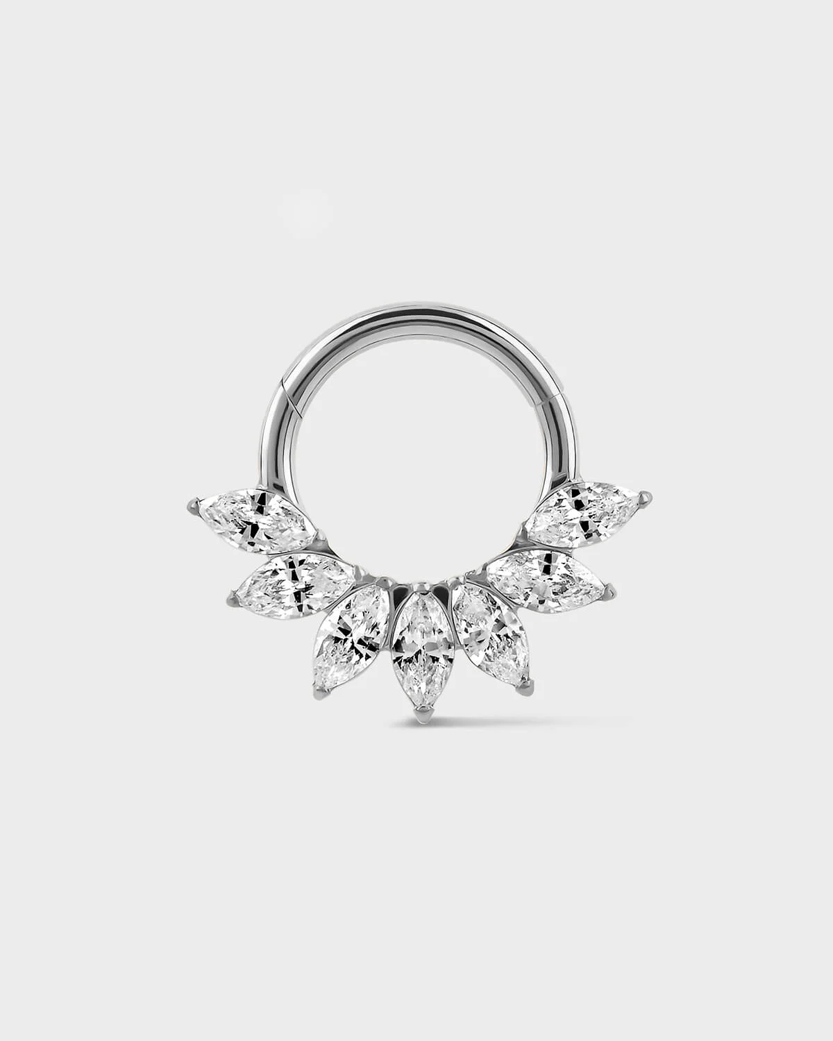 Daith Septum ring in polished titanium with seven marquise gemstone in a fan formation on a light gray background