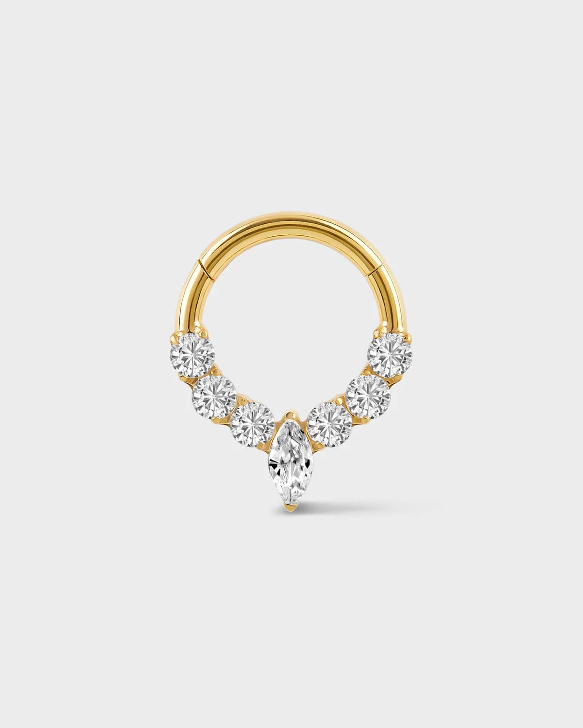 Gold daith ring with central marquise gemstone and three gem either side on a light gray background