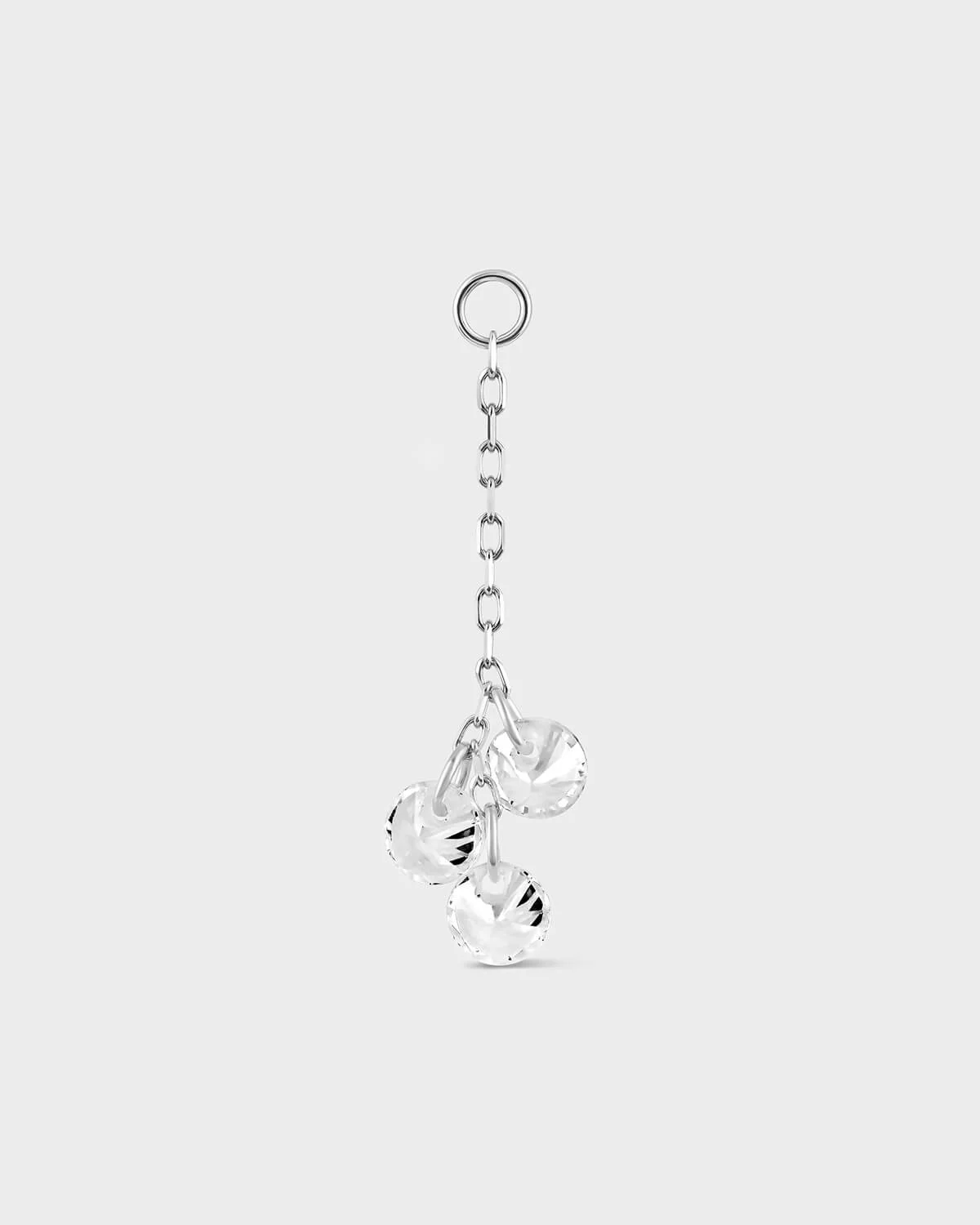 White gold earring chain with three clear crystal pendants on a white background