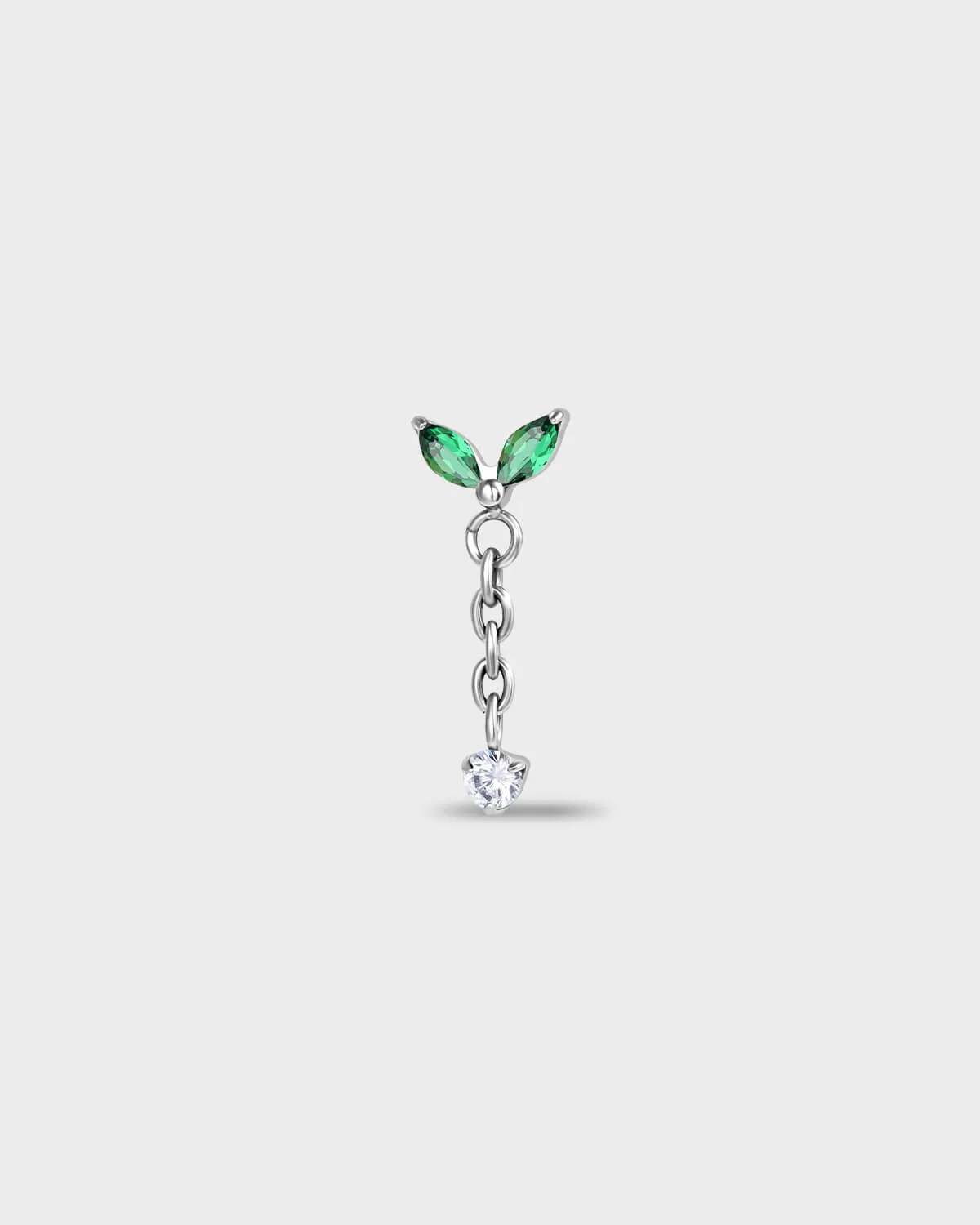 Polished titanium earring with two marquise-cut green stones and a short chain detail, finished with a clear round-cut gem on a light gray background.