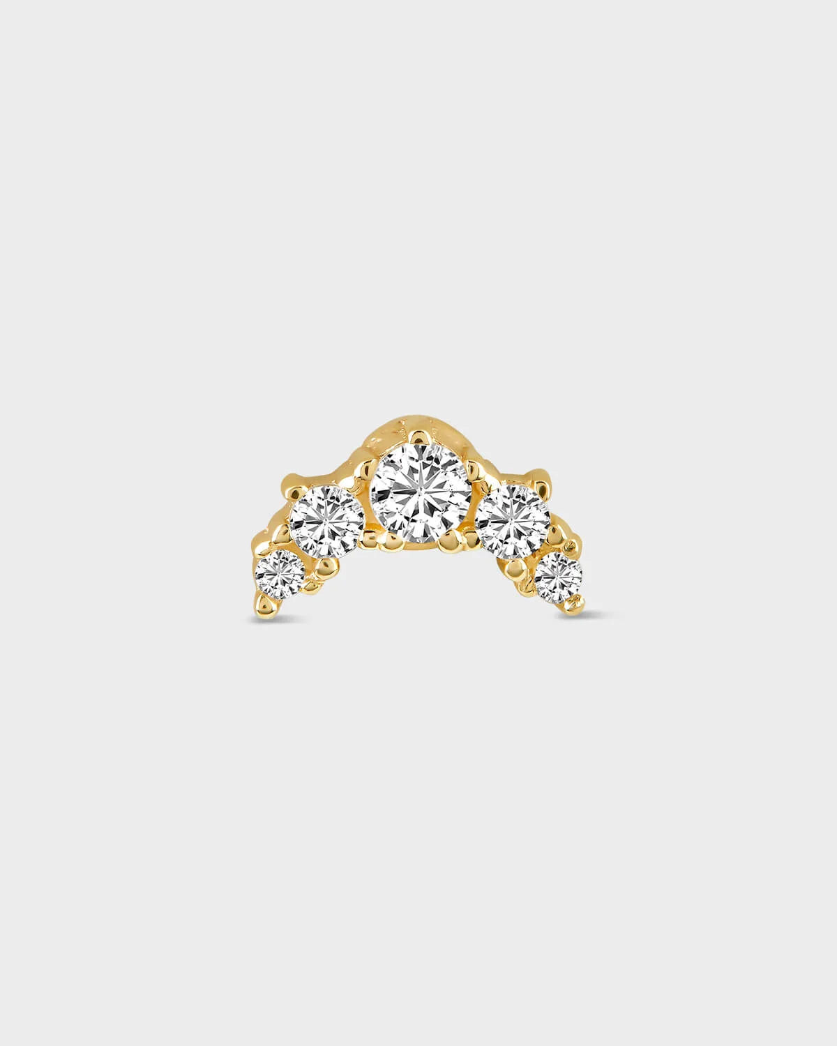 Gold earring with five diamonds on a light gray background