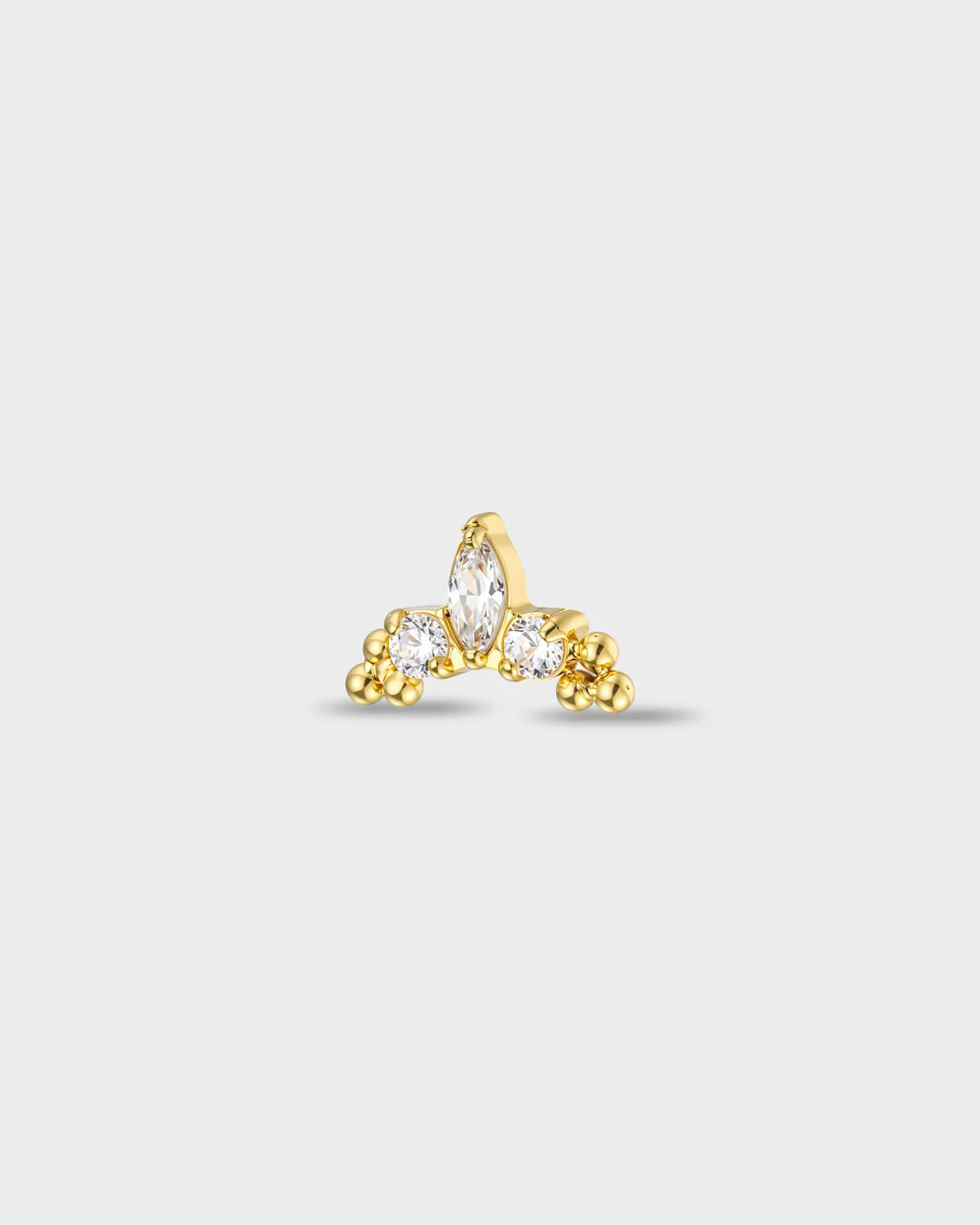 Gold titanium earring with a marquise-cut clear stone set between two round-cut clear stones, finished with polished bead details at each side, on a light gray background.