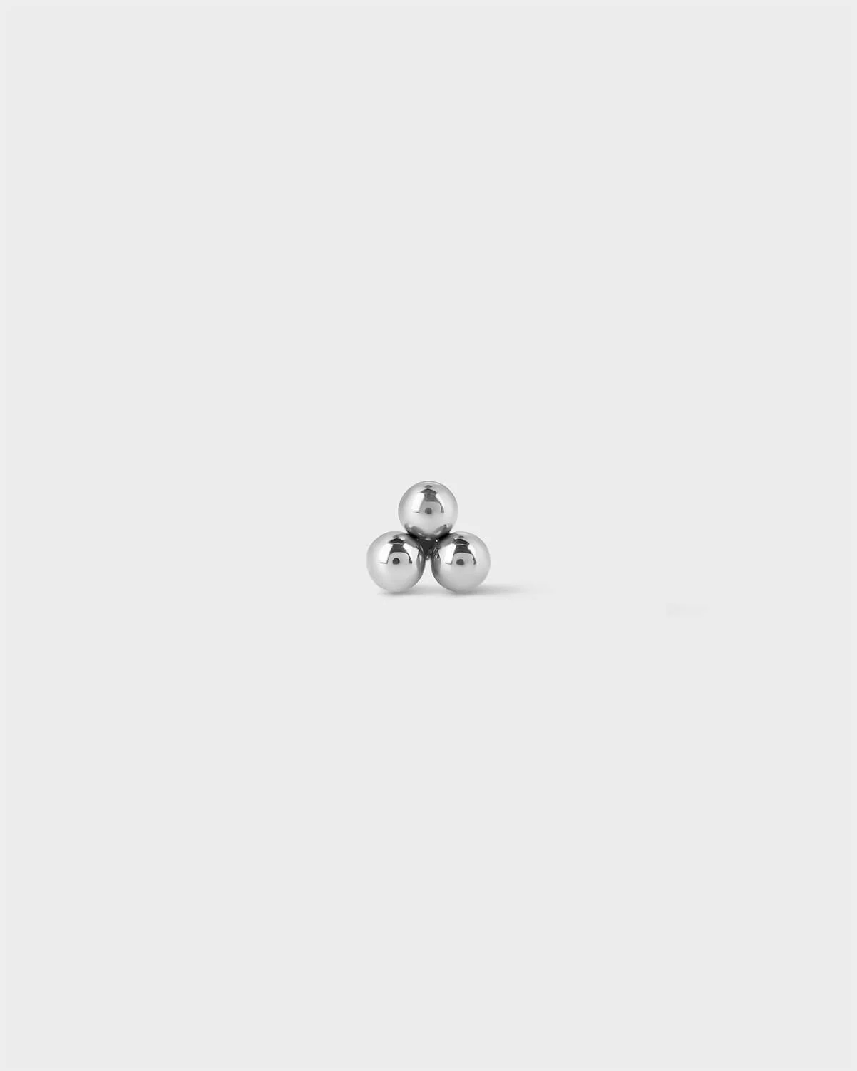Titanium threadless end featuring a polished three-bead cluster in a minimal triangular arrangement.