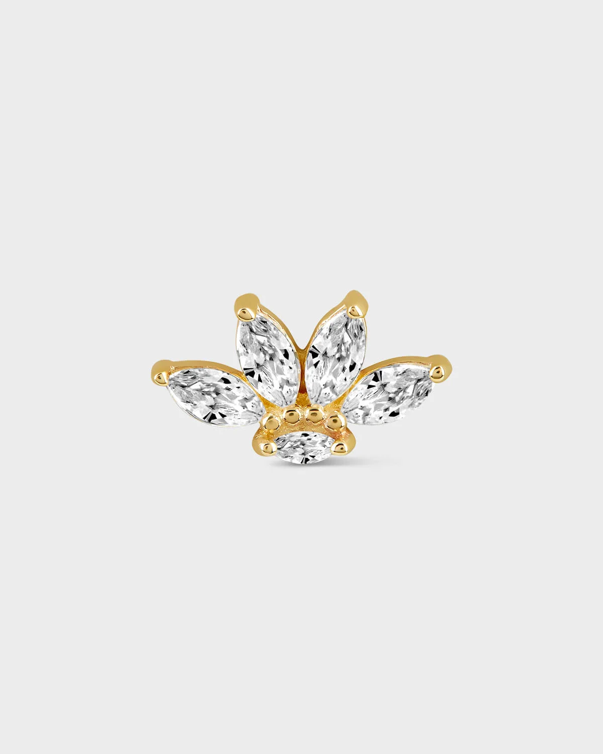 Shaped earring with clear gemstones on a light gray background