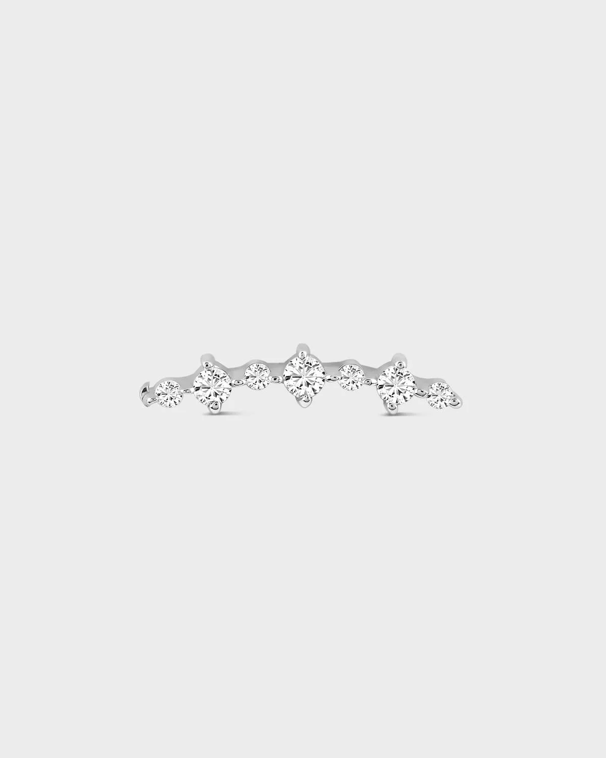Silver earring with multiple diamonds on a light gray background