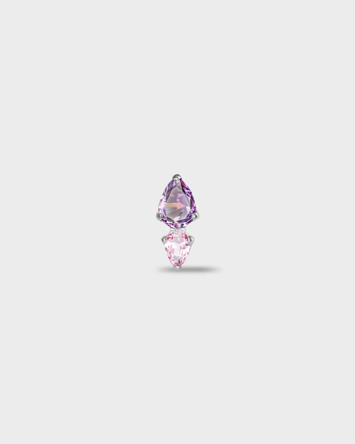 Polished silver titanium earring with a pear-cut purple stone set above a smaller pear-cut pale pink stone on a light gray background.
