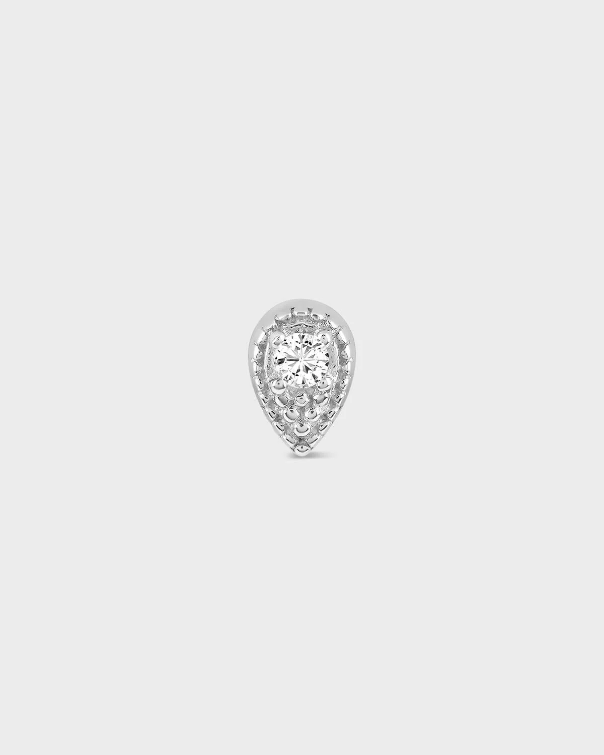 Teardrop-shaped diamond earring on a light gray background