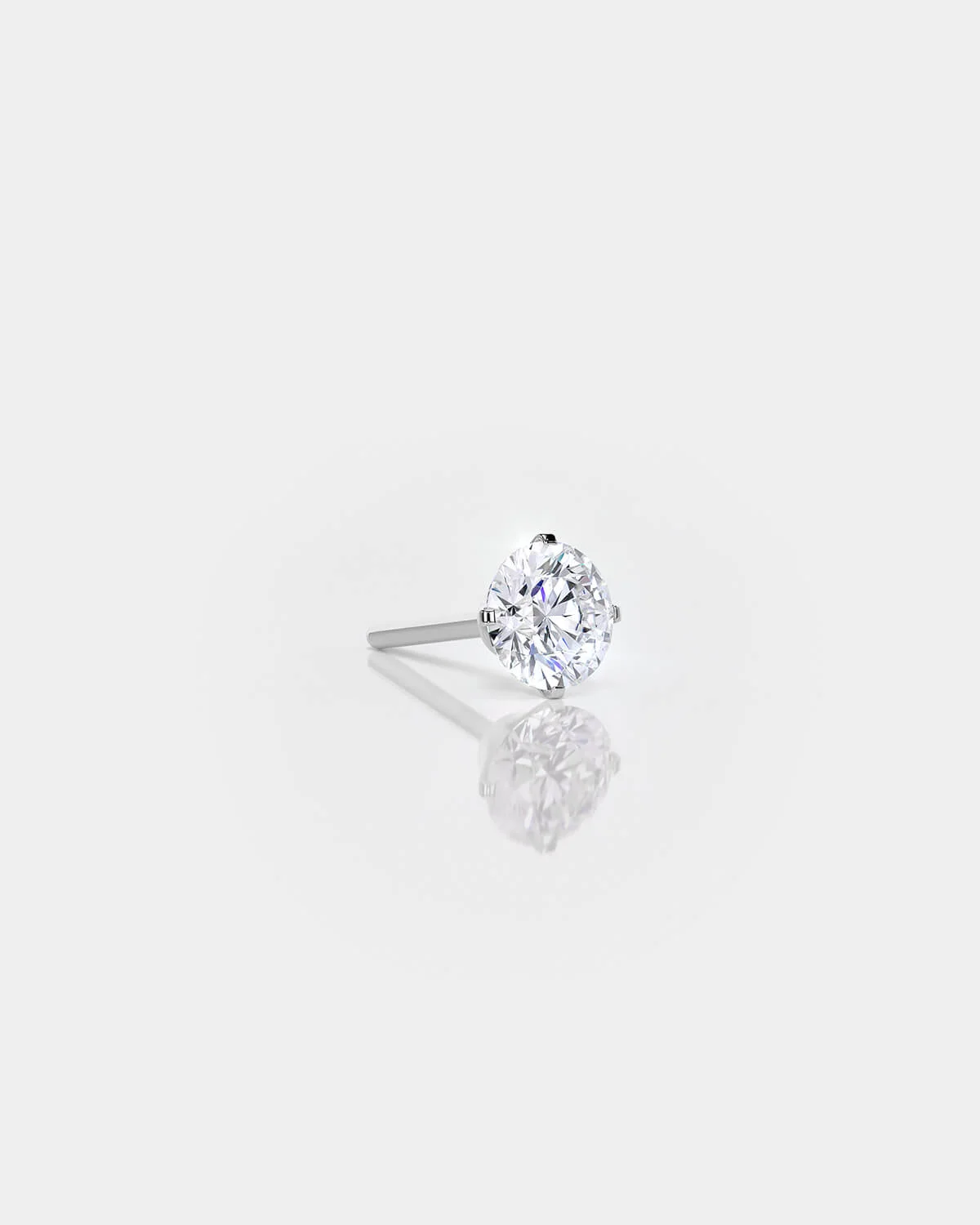 Diamond stud earring on a light gray background