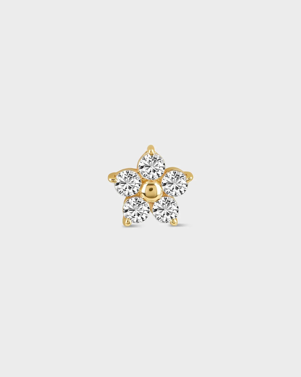 Flower shaped diamond earring on a light gray background