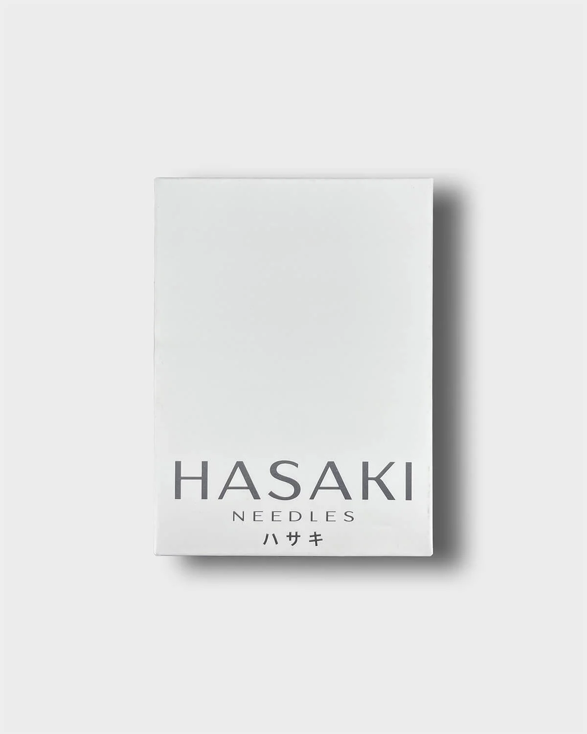Outer box of hasaki piercing needles on a light grey background