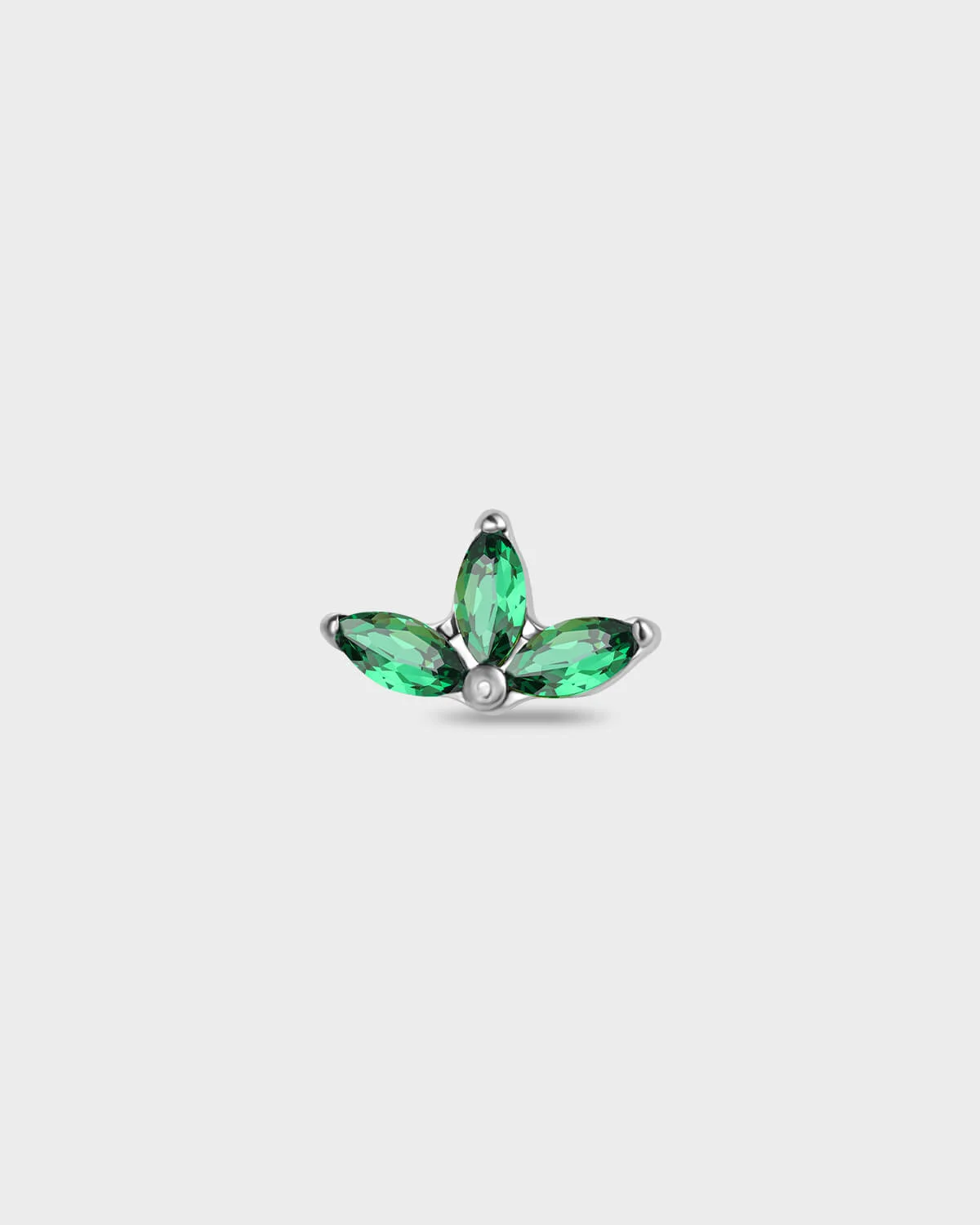 Polished titanium earring with three emerald green marquise gemstones on a light gray background